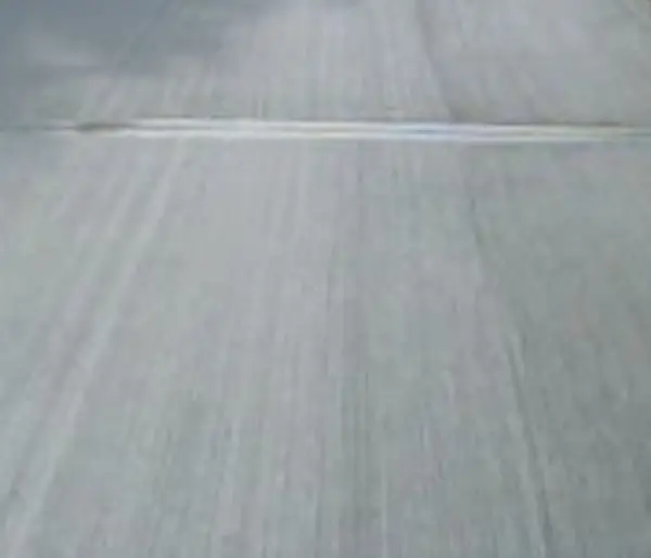 Hand performing a touch test on cured cement sealer to check for dryness and adhesion